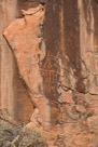 I try to record every glyph at a site. So. I started with the first glyphs I could find which were a little downstream from the main panels but on the same cliffs. If you look closely he has a right arm with three fingers and an elbow indicated. Any left arm has been spalled off. The bottom is too indistinct to determine is 'legs' are indicated or just more interior lines. There are possible 'eyes' and 'horns'. To the left and below this glyph and on the adjacent rock face there is pecking that appears to be purposeful but I can see no pattern. Remineralization may obscure part of this pattern. Or it may just be where an artist practiced.