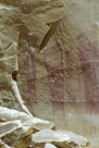 These are obviously purposefully drawn figures. The one at the left has two 'eyes' and two 'antanae' or feathers indicated.  There is definite internal structure in the body torso and legs and feet are indicated. Most detail in on the right (his left or her left) arm and hand where at least 4 individual fingers and an elbow are indicated.    
The middle figure is harder to figure. Three vertical 'feathers' and three internal structures. Is the number three significant??   The figure has two token feet. 
And the figure at the right is the hardest to get a grasp on.  There appears to be a top 'cover' of some sort over a tapered torso. There may be internal structure.  A better picture in better lighting might be manipulated in Lightroom and/or Photoshop to reveal more detail.