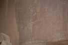 The next panel down stream. A couple of Fremont figures with feathers tilted the right. Hands are generally fully digitized. Head treatment appears to be similar but only one figures has legs. Note that the big horn sheep has cloven hoves. And note that there is a very old petroglyph under this (between the two Fremont figures).