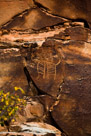 I will work from left to right down the cliff face. This glyph was not in the previous overall view. A simple Dinwoody style character. Interior lines, mask like head, arms with three finger hands indicated. No legs. Indistinct pecking adjacent to the head and right hand.