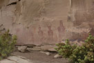 Again on the eastern canyon by the corral is this panel. Lots of stuff going on here. Horned figures, feathered? figures, tall figures short figures. Figures in different colors. And along the bottom of the panel are petroglyphs that appear to be applied after the Barrier Canyon style figures.  I judge the petroglyph figures to be Fremont, larger painted pictographs Barrier Canyon. And don't overlook the requisite bullet holes.